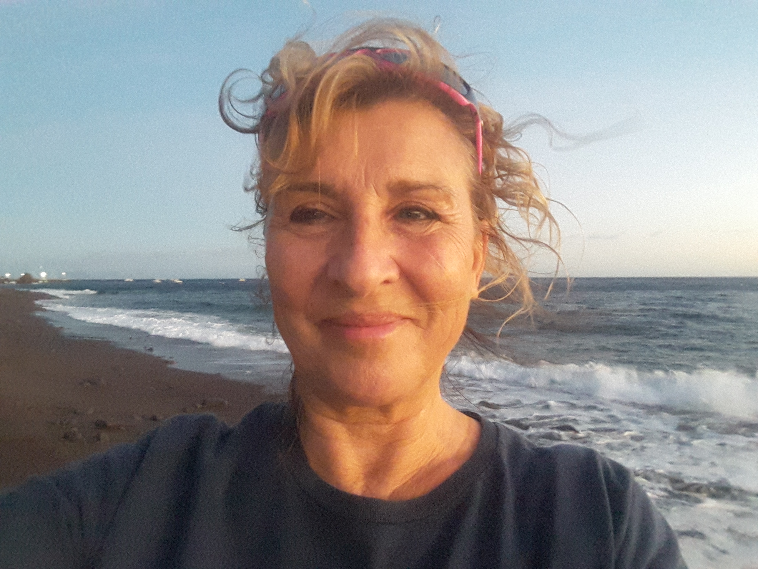 Cheryl Butterworth smiling on a windswept beach